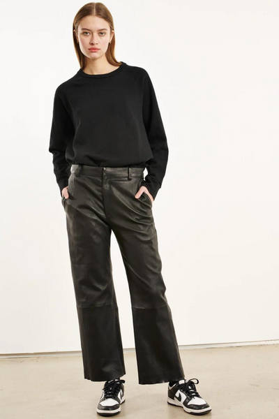 Model wearing SPRWMN Cropped Baggy Lowrise Trousers front view