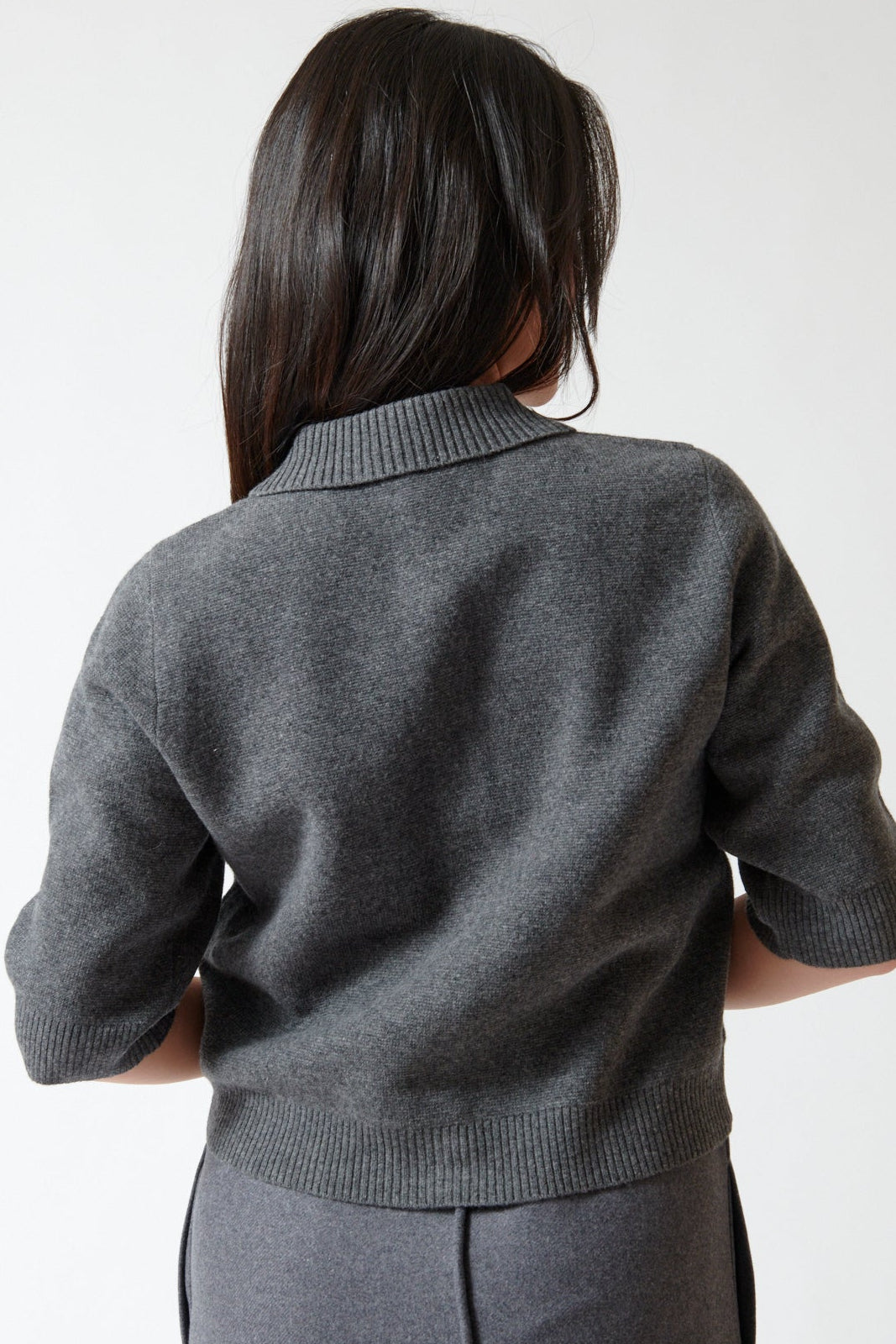 Lilly wearing The Garment Como Short Cardigan rear view