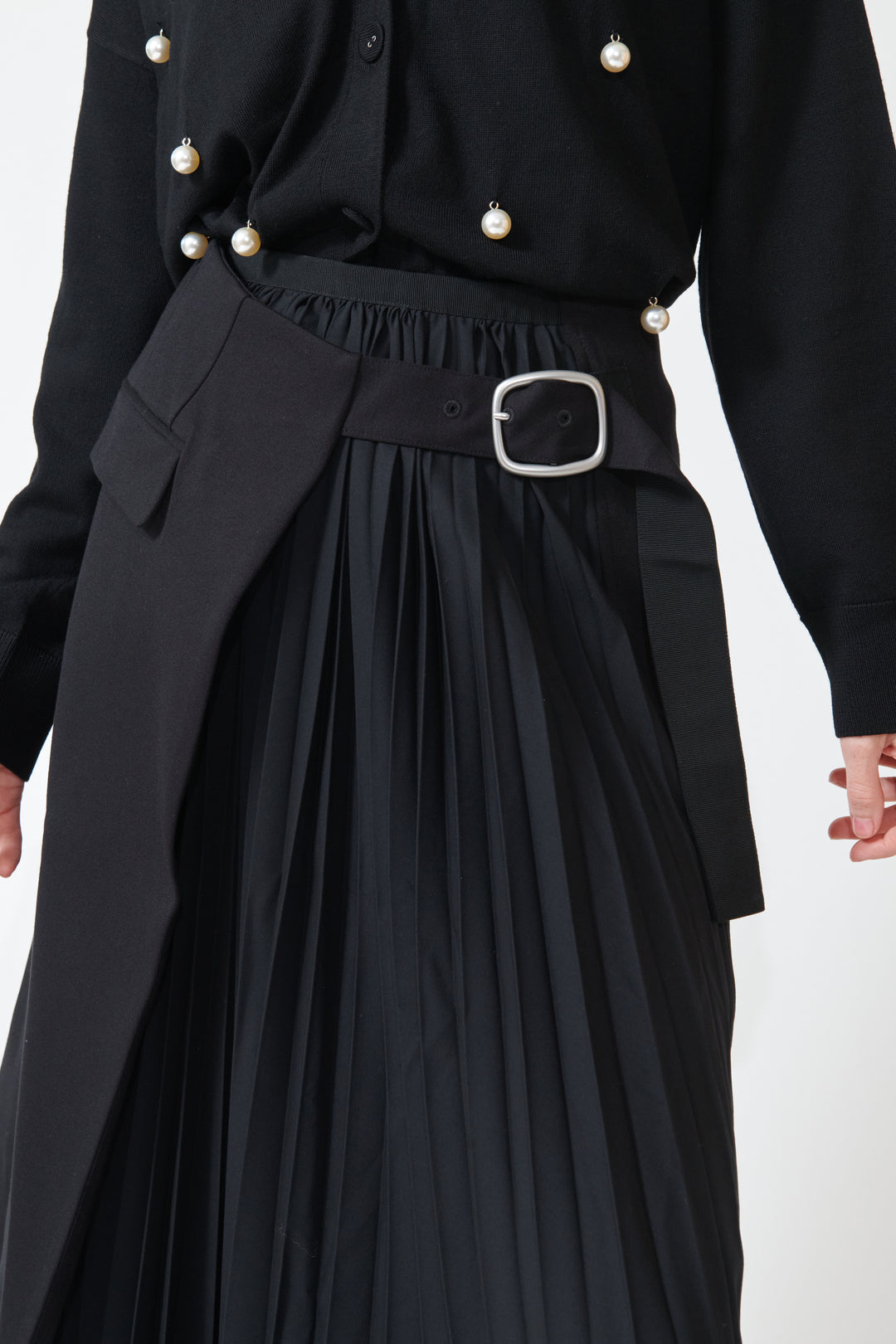 Madi wearing Buckled Flat And Pleated Wrap Skirt Black detail view