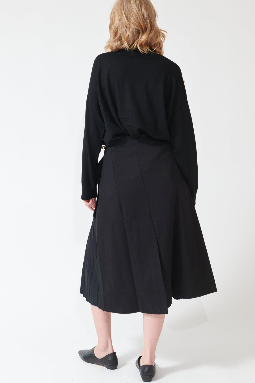Madi wearing Buckled Flat And Pleated Wrap Skirt Black rear view