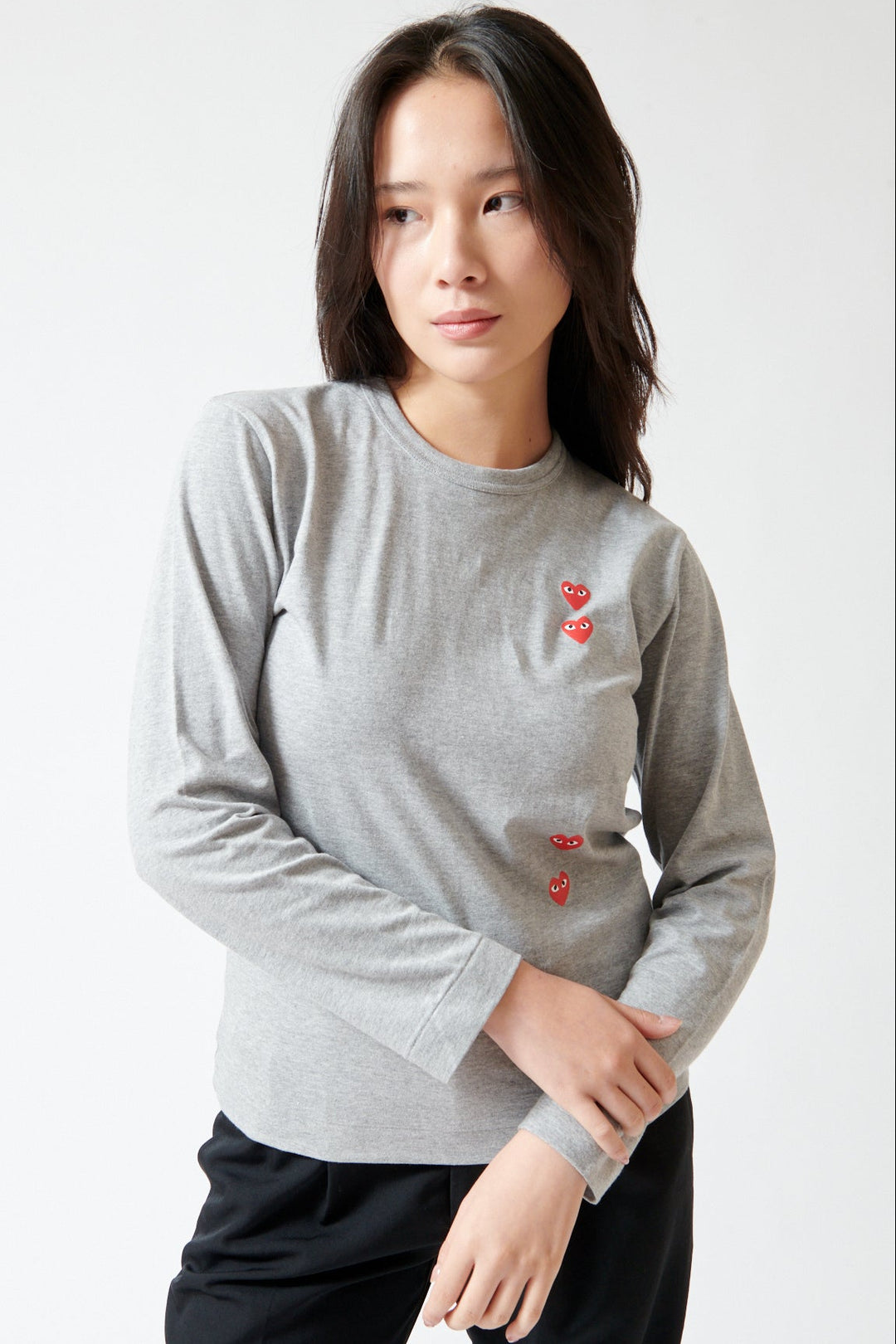Lilly wearing Comme des Garçons PLAY Duo Pair Heart Logo Print Long Sleeve T-Shirt front view