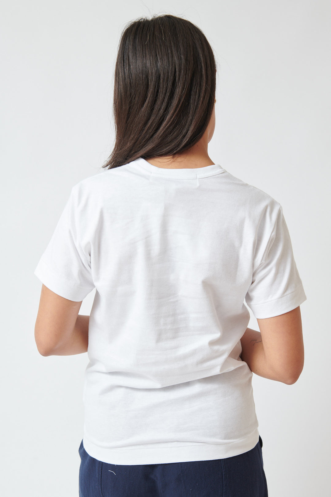 Amanda wearing Comme des Garçons PLAY Logo Heart Print Studded Tee rear view