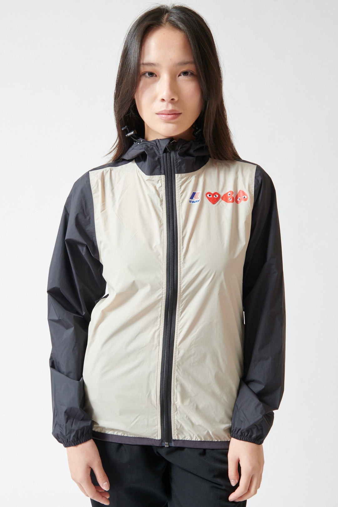Lilly wearing Comme des Garçons PLAY K-Way Full Zip Red Emblem Jacket front view