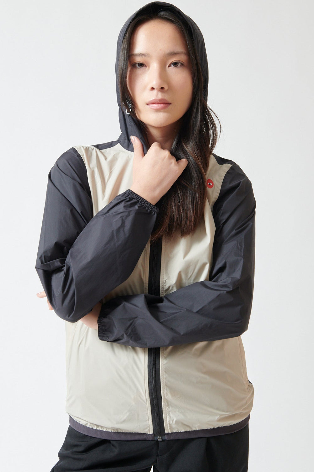 Lilly wearing Comme des Garçons PLAY K-Way Full Zip Red Emblem Jacket front view