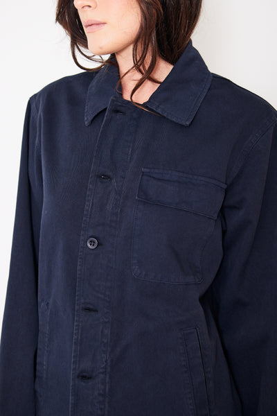Close up front view of model wearing navy blue button up jacket