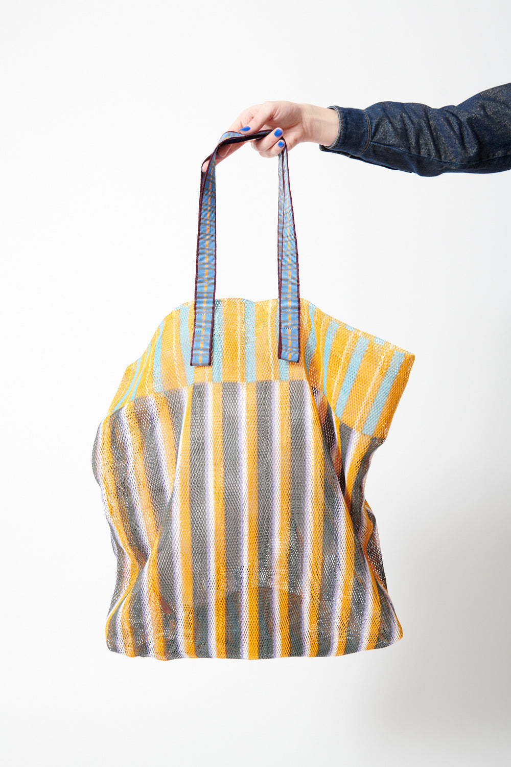Model holding Épice Extra Large Stripe Mesh Tote