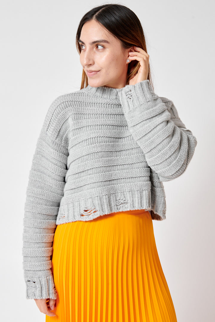 Maria wearing MM6 Maison Margiela Distressed Horizontal Links Crop Sweater front view