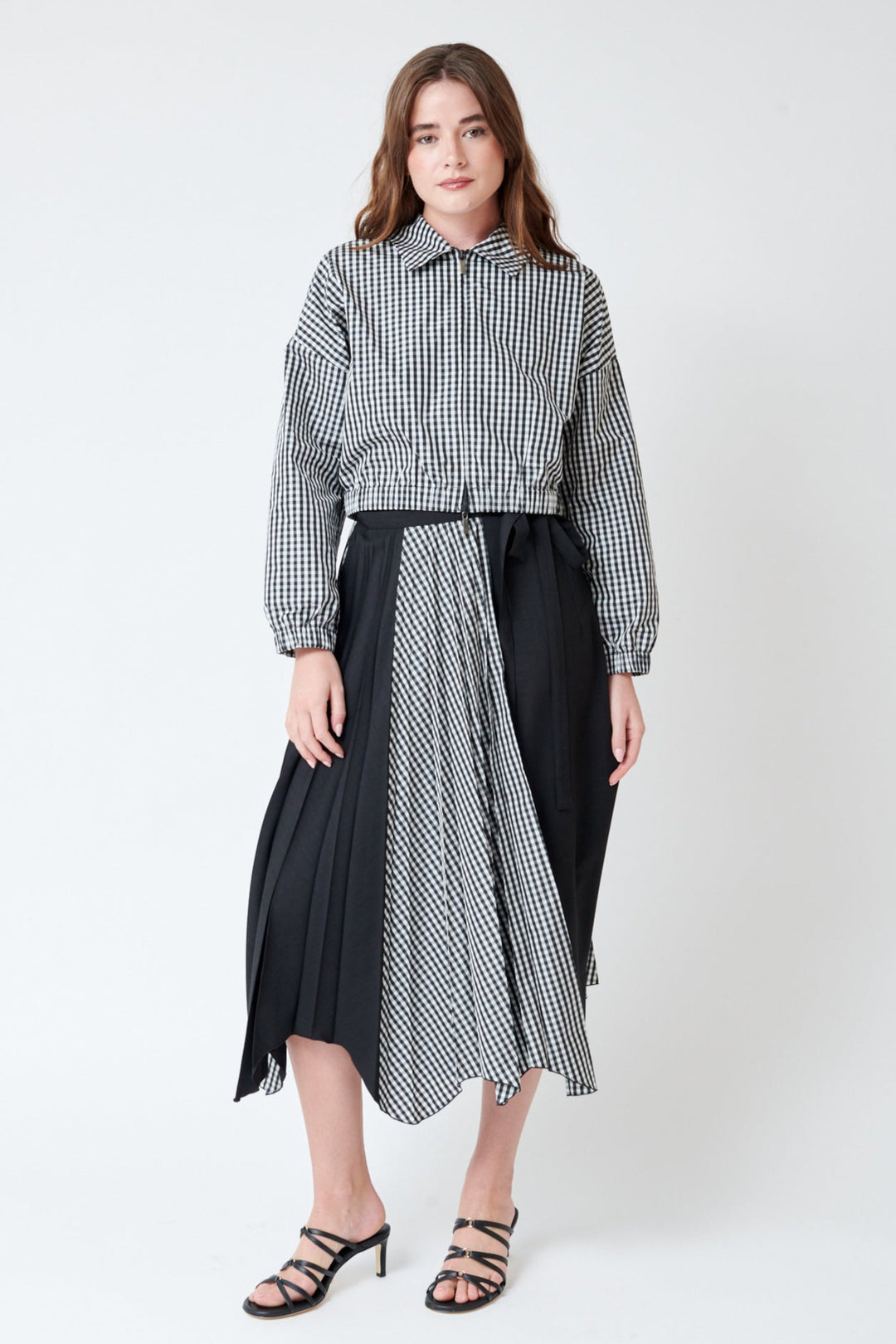 Julia wearing SFIZIO Scalloped Hem Pleated Wrap Skirt front view