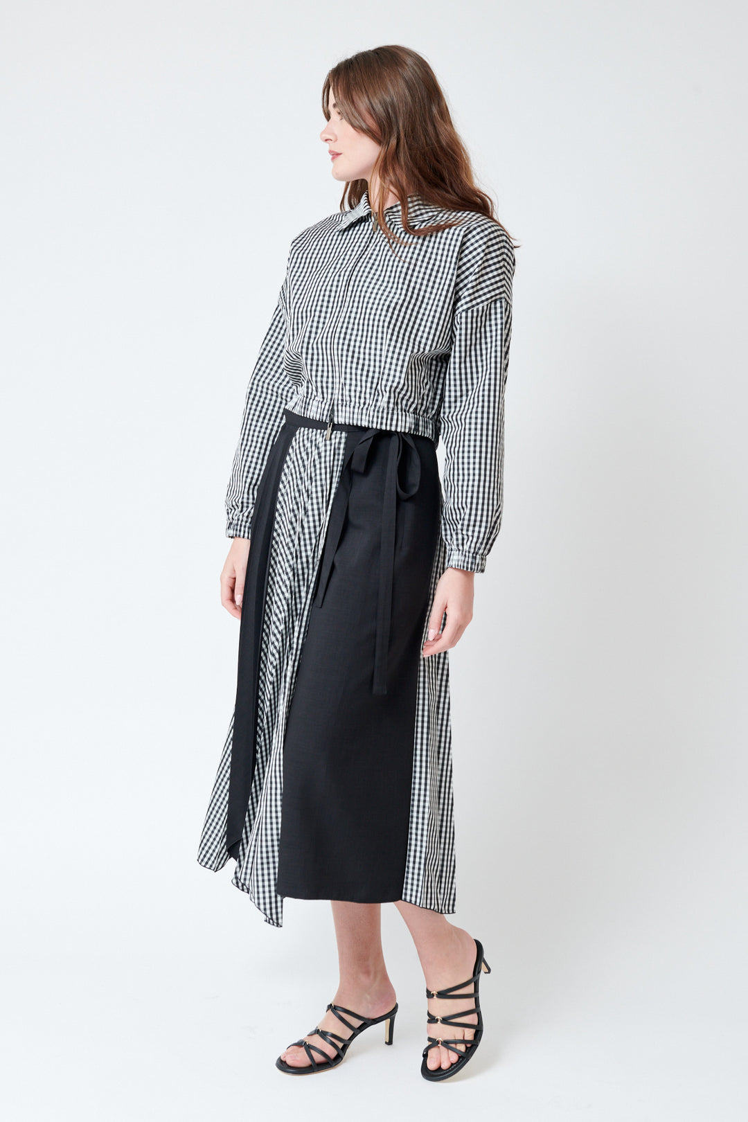 Julia wearing SFIZIO Scalloped Hem Pleated Wrap Skirt front/side view