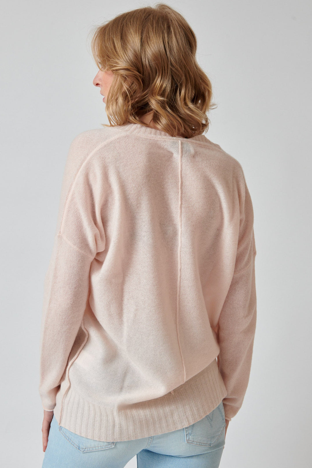 Madi wearing KUJTEN Elena Deep V Sweater rear view