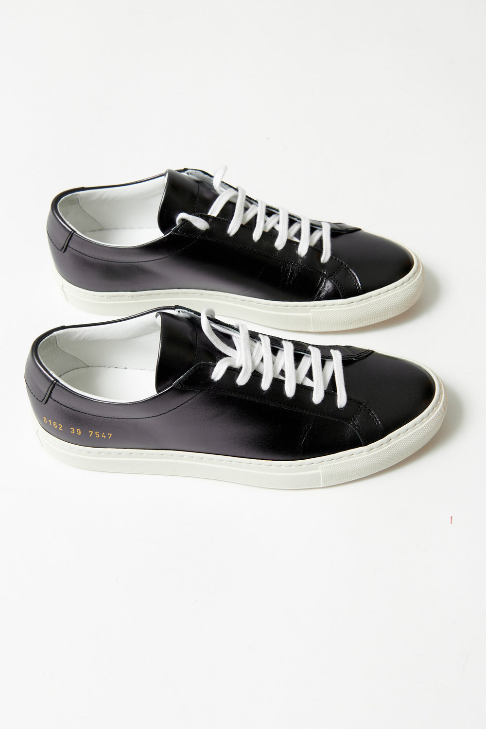 Flat lay of Common Projects Achilles Shiny side view