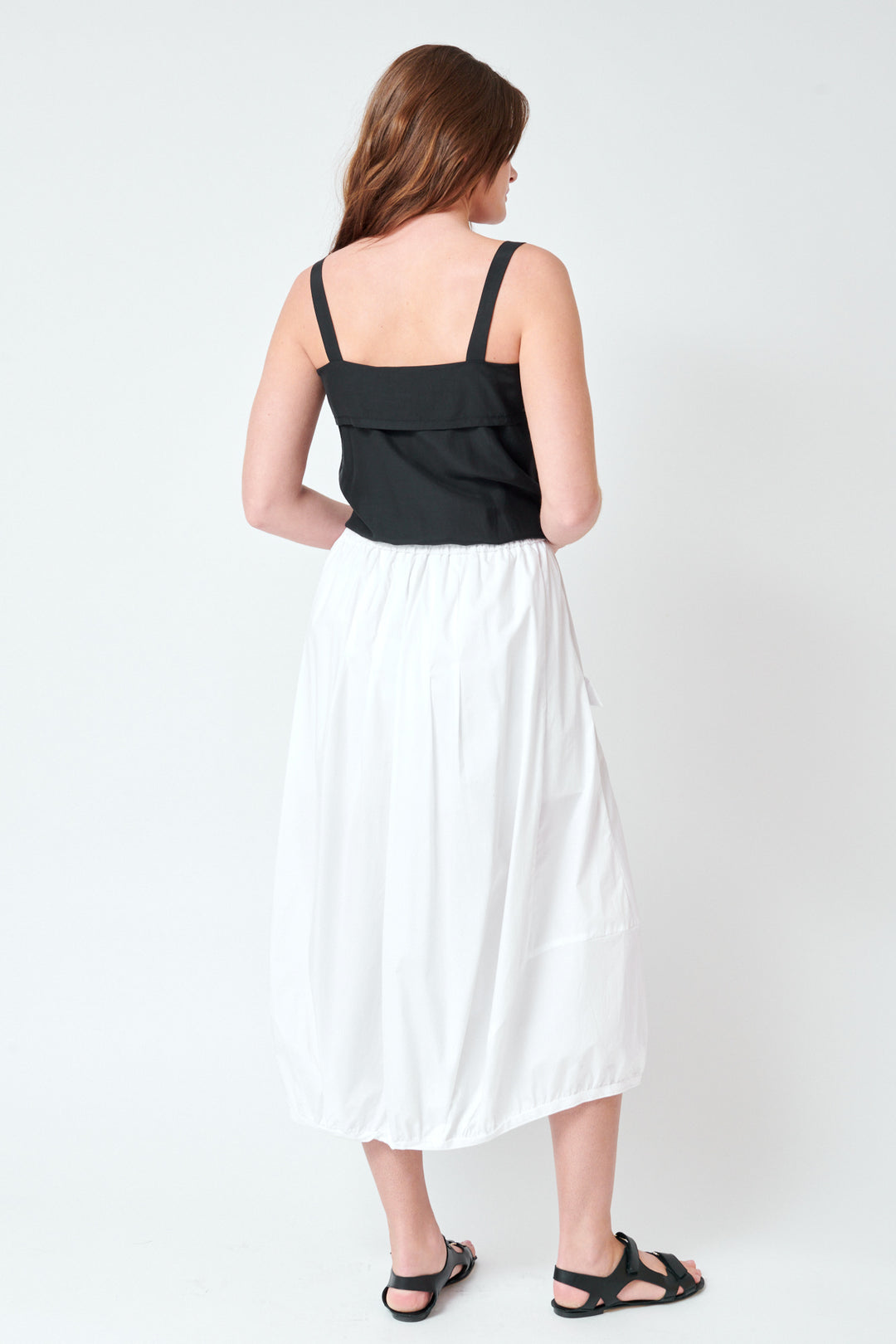 Julia wearing Tela Spire Skirt rear view