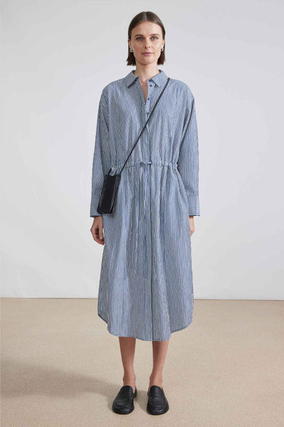 Front view of model wearing long sleeve button up striped shirt dress