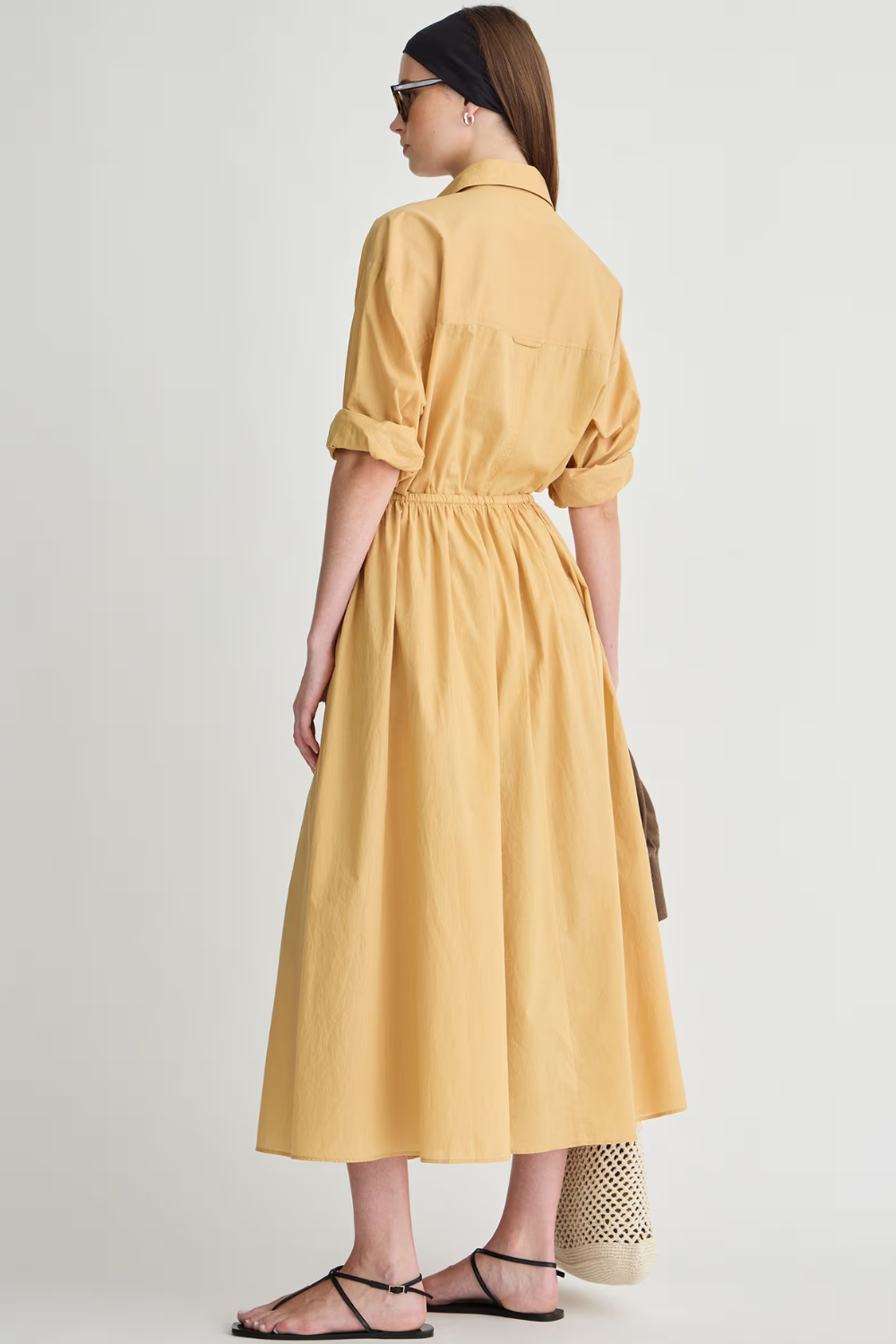 Model wearing Apiece Apart Priska Shirt Dress rear view