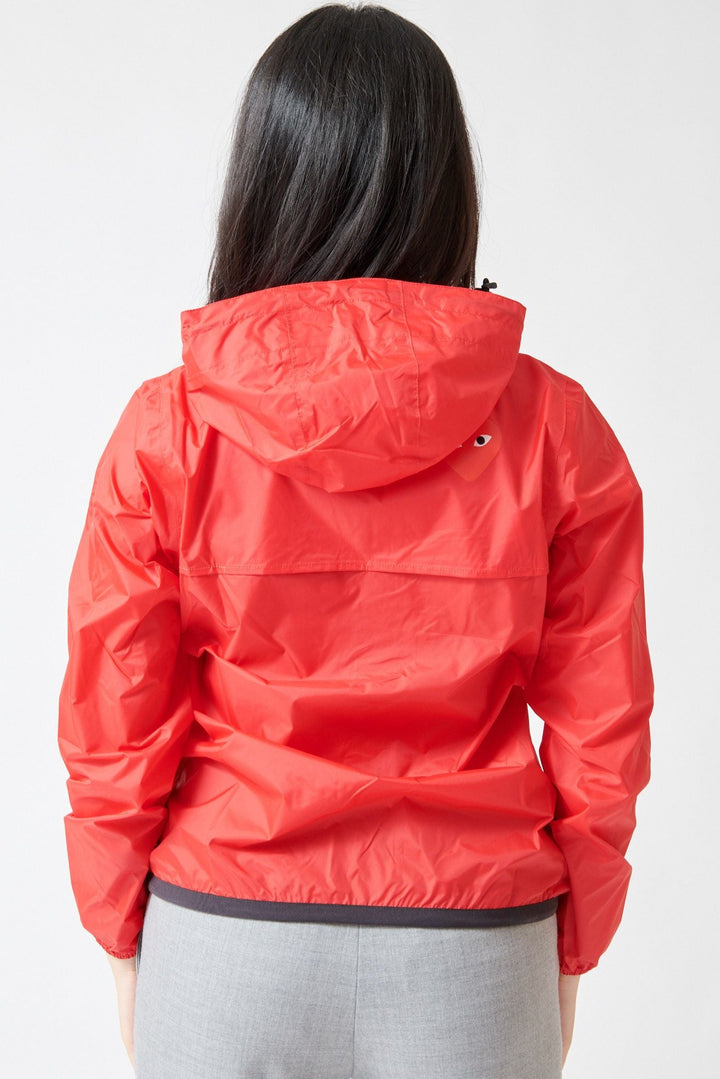 Lilly wearing Comme des Garçons PLAY K-Way Full Zip Red Emblem Unisex Jacket Red rear view