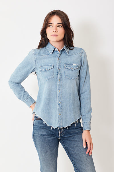 Front view of model wearing light blue distressed denim shirt with snaps
