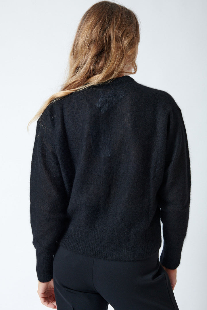 Mari wears sizing Apiece Apart Softest Tissue Weight Sweater rear view