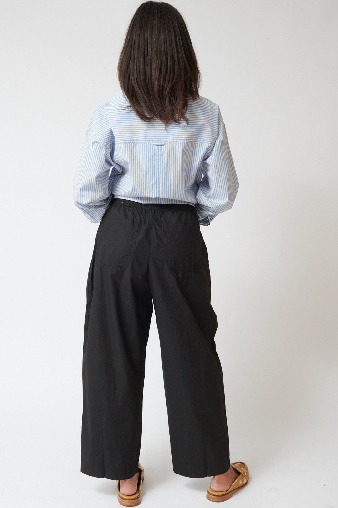 Amanda wearing Apiece Apart Spa Pleat Pant rear view