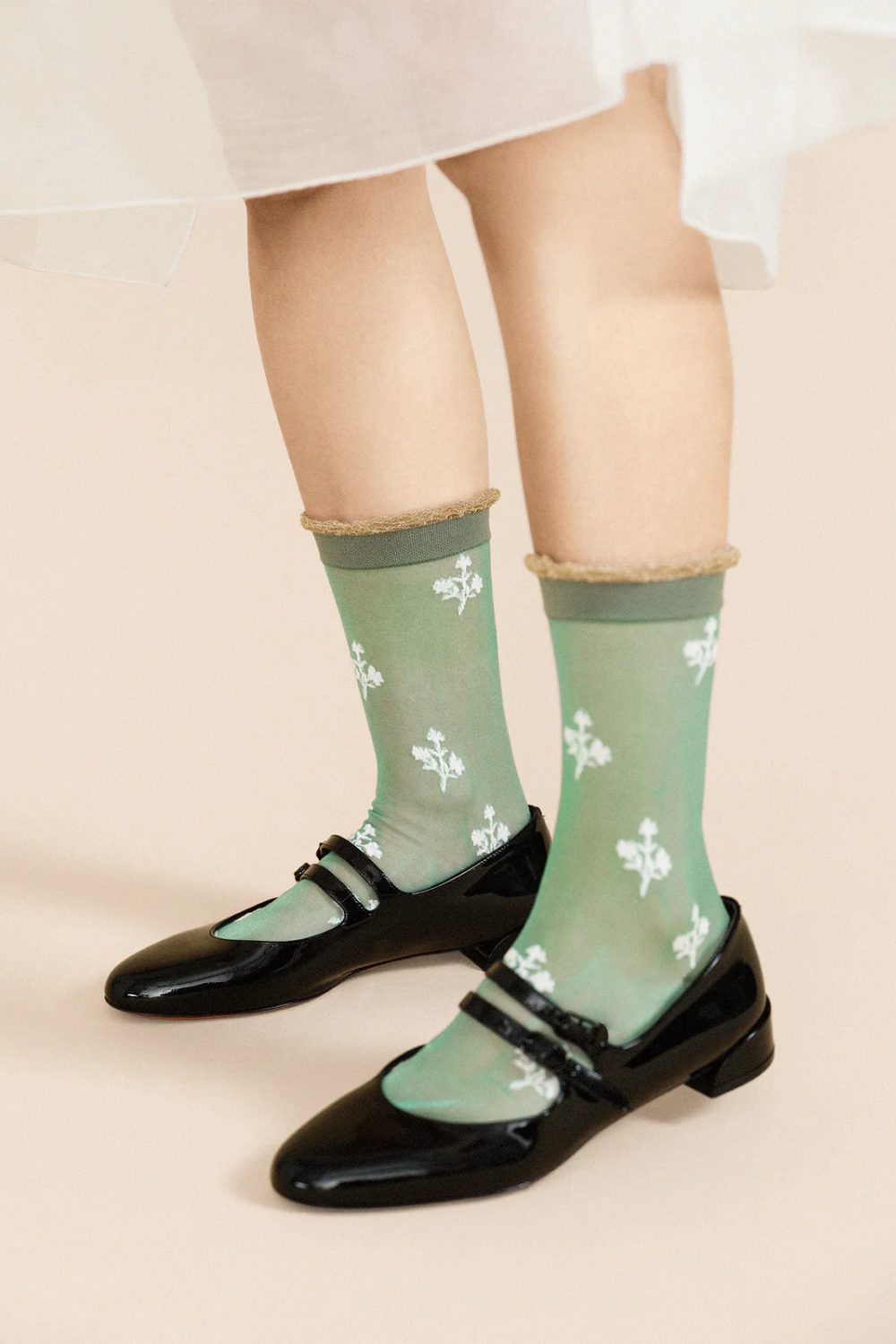 Model wearing Hansel From Basel Floral Clover Sheer Crew front/side view
