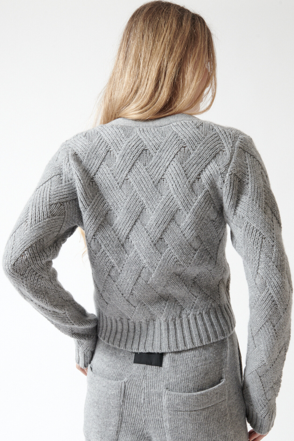 Mari wearing Allude Wool Cashmere Diagonal Weave V Cardigan rear view