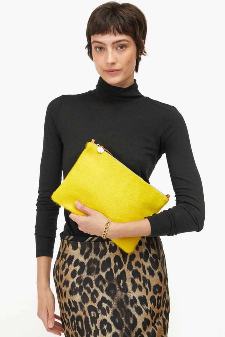 Model wearing Clare V. Flat Clutch w/ Tabs front view