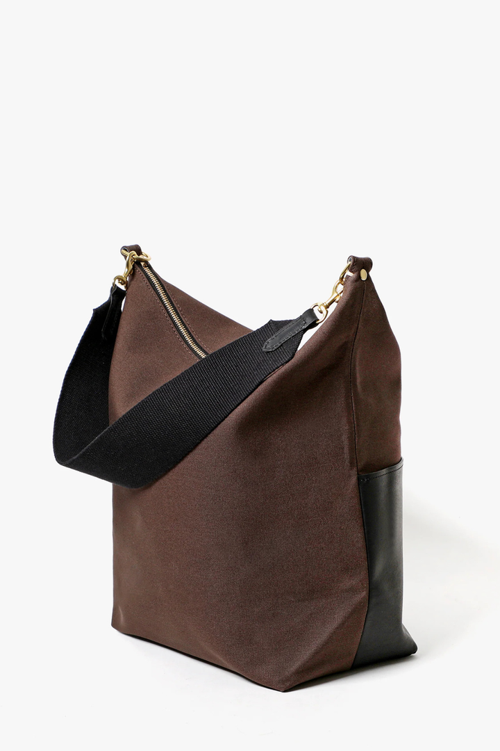 Flat lay of  Clare V. Canvas w/ Veg Sophie Bag front/side view