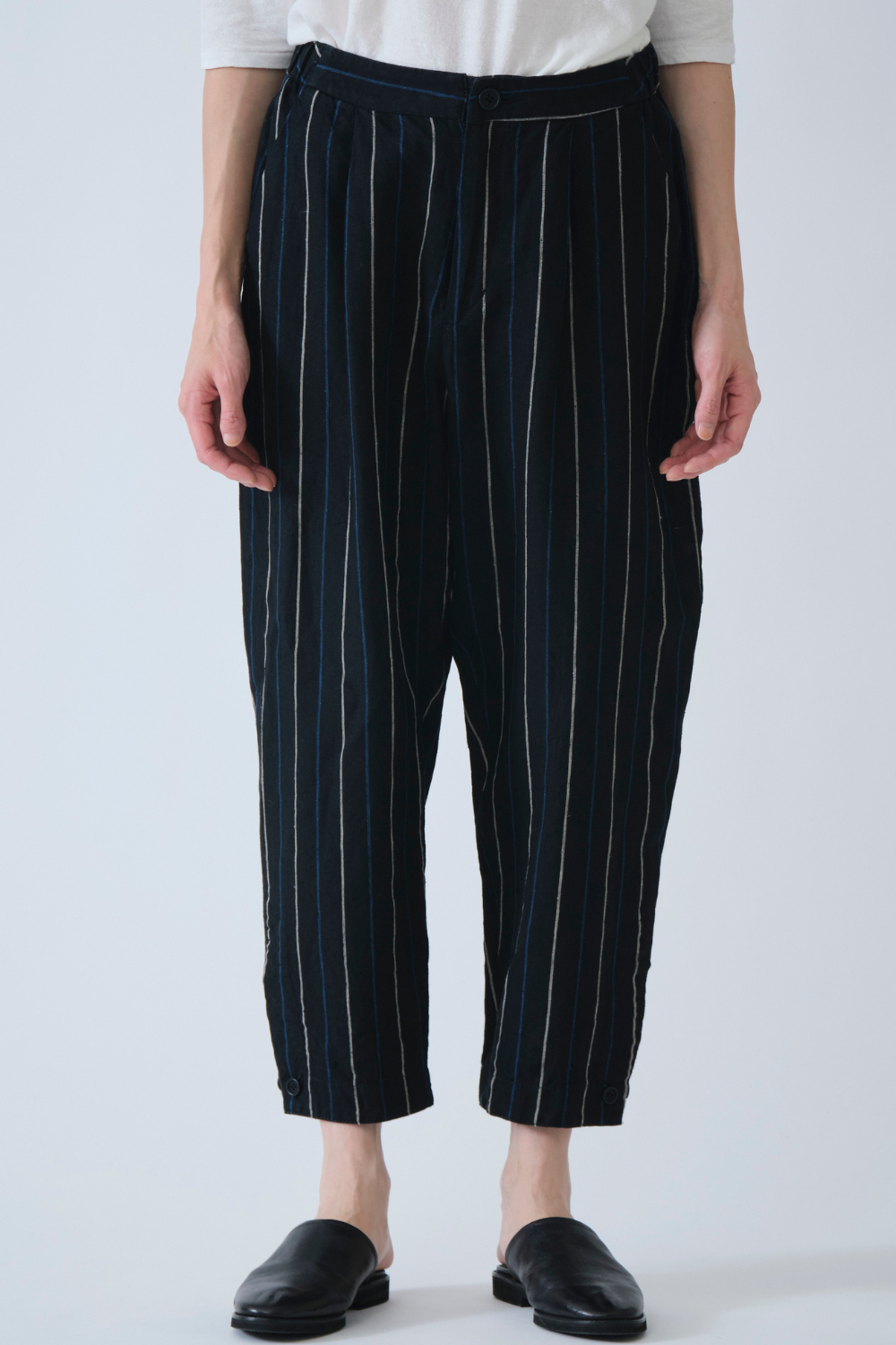 Model wearing Pas de Calais Linen Indigo Stripe Cropped Pants front view