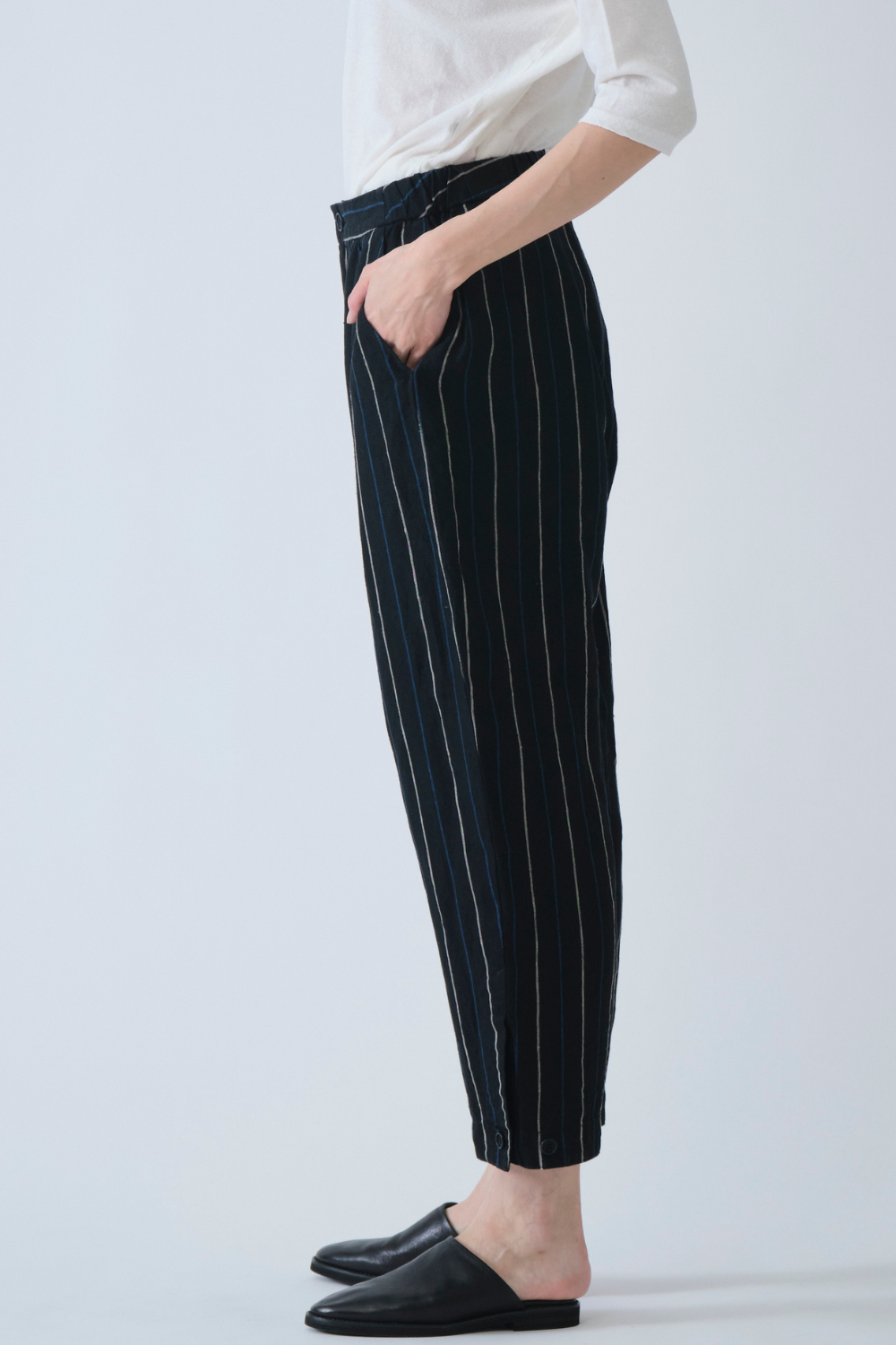 Model wearing Pas de Calais Linen Indigo Stripe Cropped Pants side view