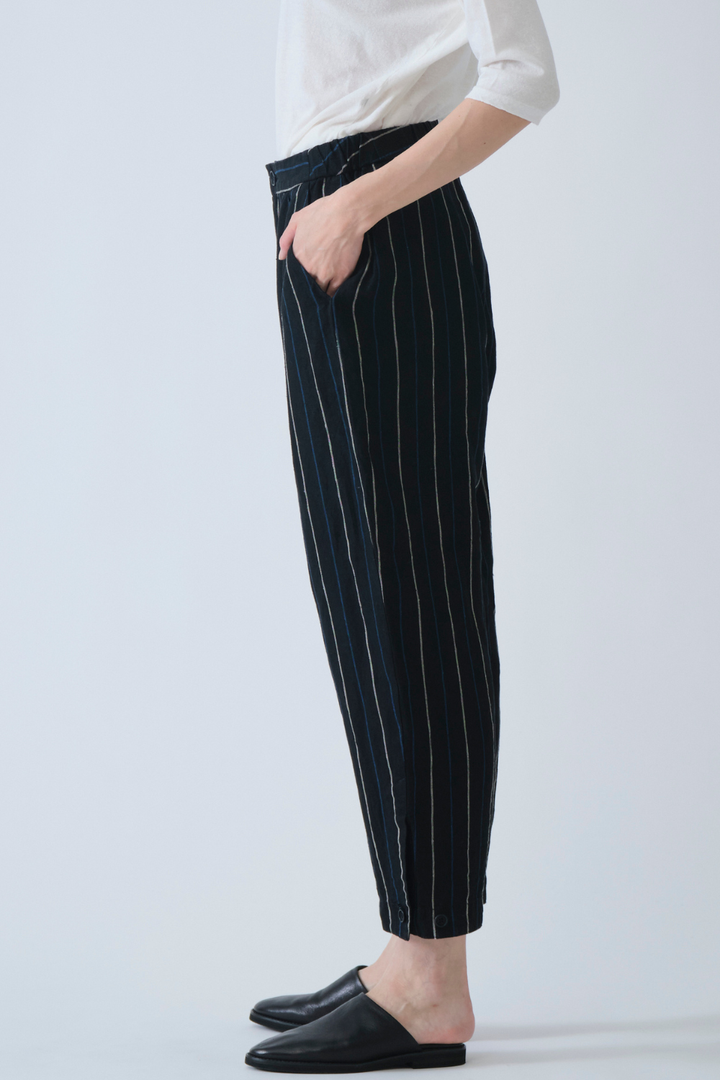 Model wearing Pas de Calais Linen Indigo Stripe Cropped Pants side view