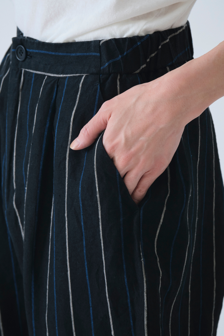 Model wearing Pas de Calais Linen Indigo Stripe Cropped Pants front/detail view