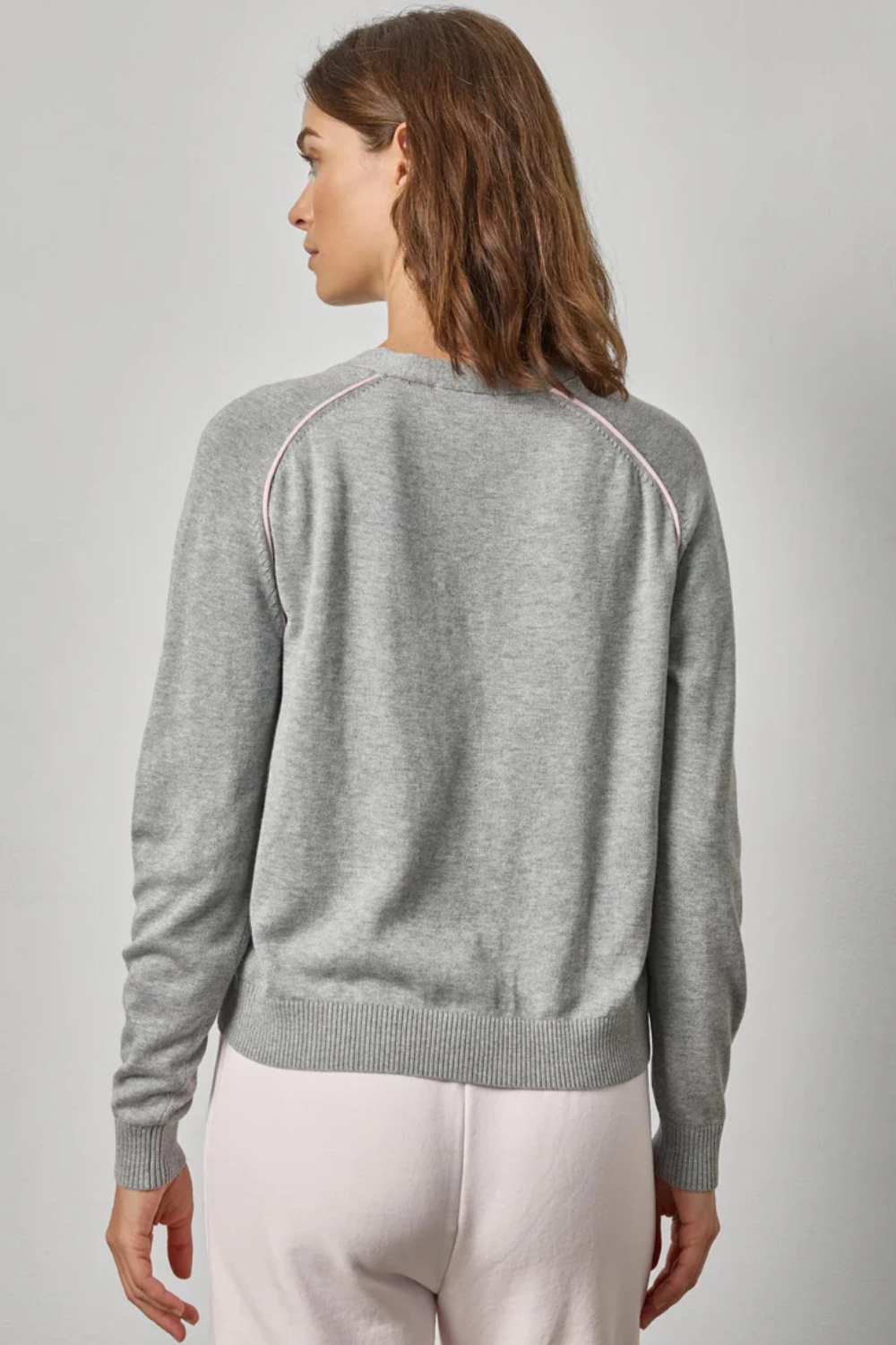 Model wearing Lilla P Saddle Sleeve V Neck Cardigan rear view