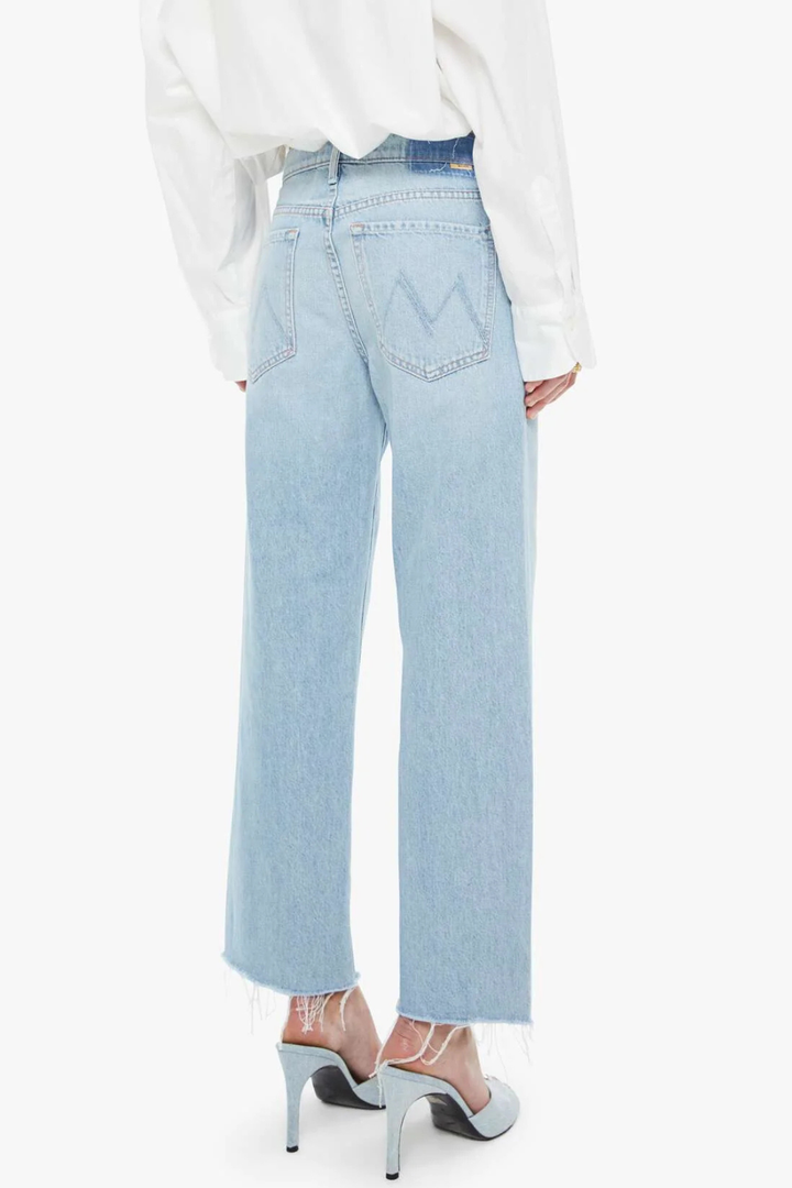 Model wearing Mother Denim Mid Rise Rambler Zip Ankle Fray rear view