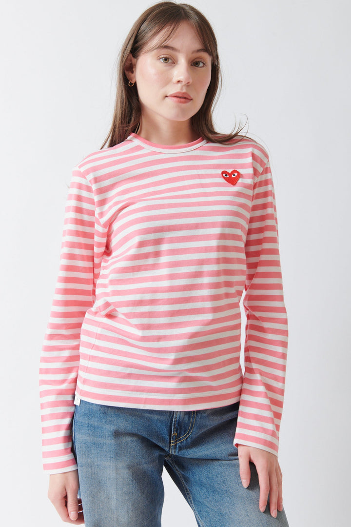 Angela wearing Comme des Garçons PLAY Red Emblem Long Sleeve Striped T Shirt Pink front view