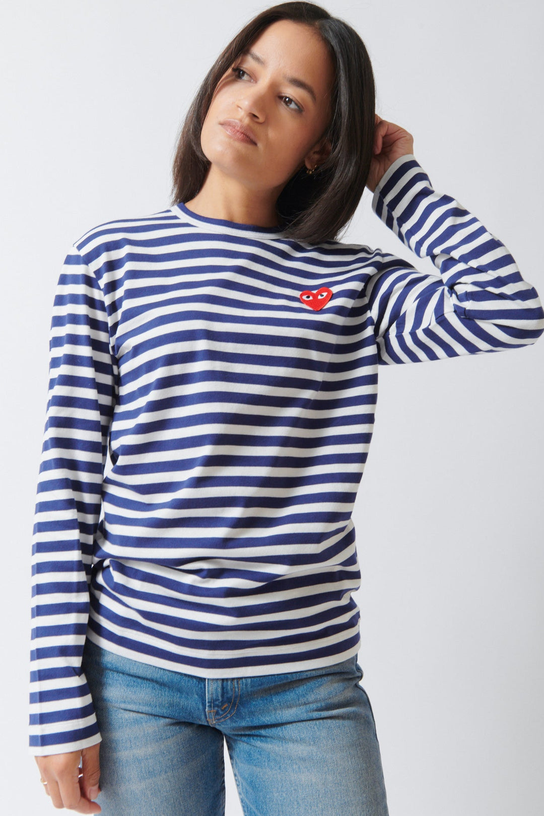 Amanda wearing Comme des Garçons PLAY Red Heart Emblem Striped Long Sleeve Tee Navy White front view