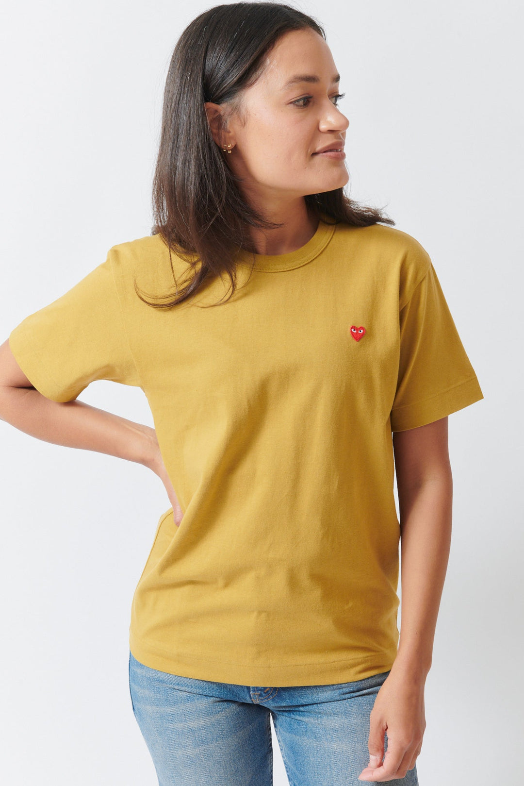 Amanda wearing Comme des Garçons PLAY Small Red Emblem T Shirt Olive Small Red Heart front view