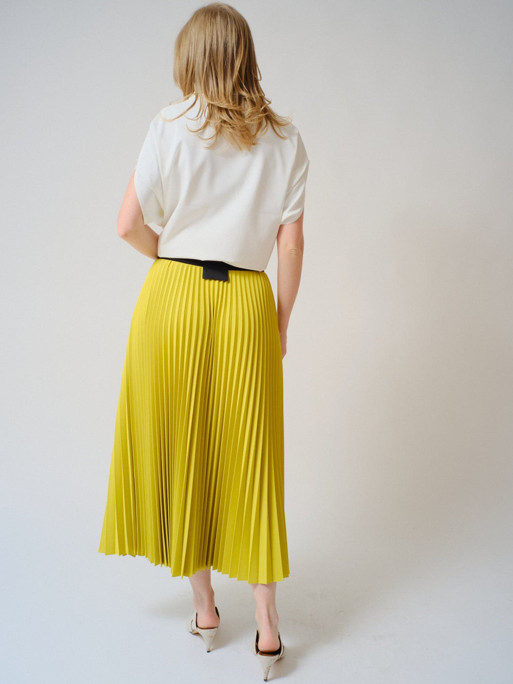 Madi wearing COG The Big Smoke Nessa Accordion Pleated Skirt rear view