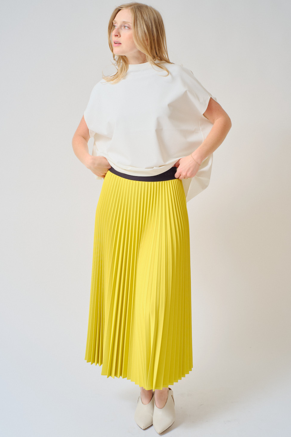 Madi wearing COG The Big Smoke Nessa Accordion Pleated Skirt front view