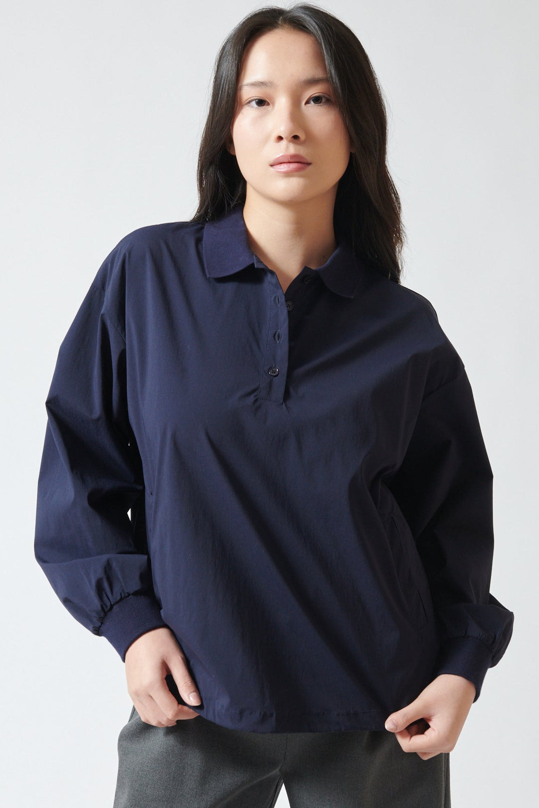 Lilly wearing ELEH Stretch Polo Henley With Pockets front view