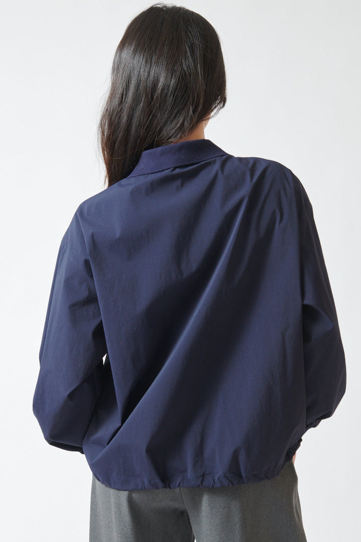 Lilly wearing ELEH Stretch Polo Henley With Pockets rear view