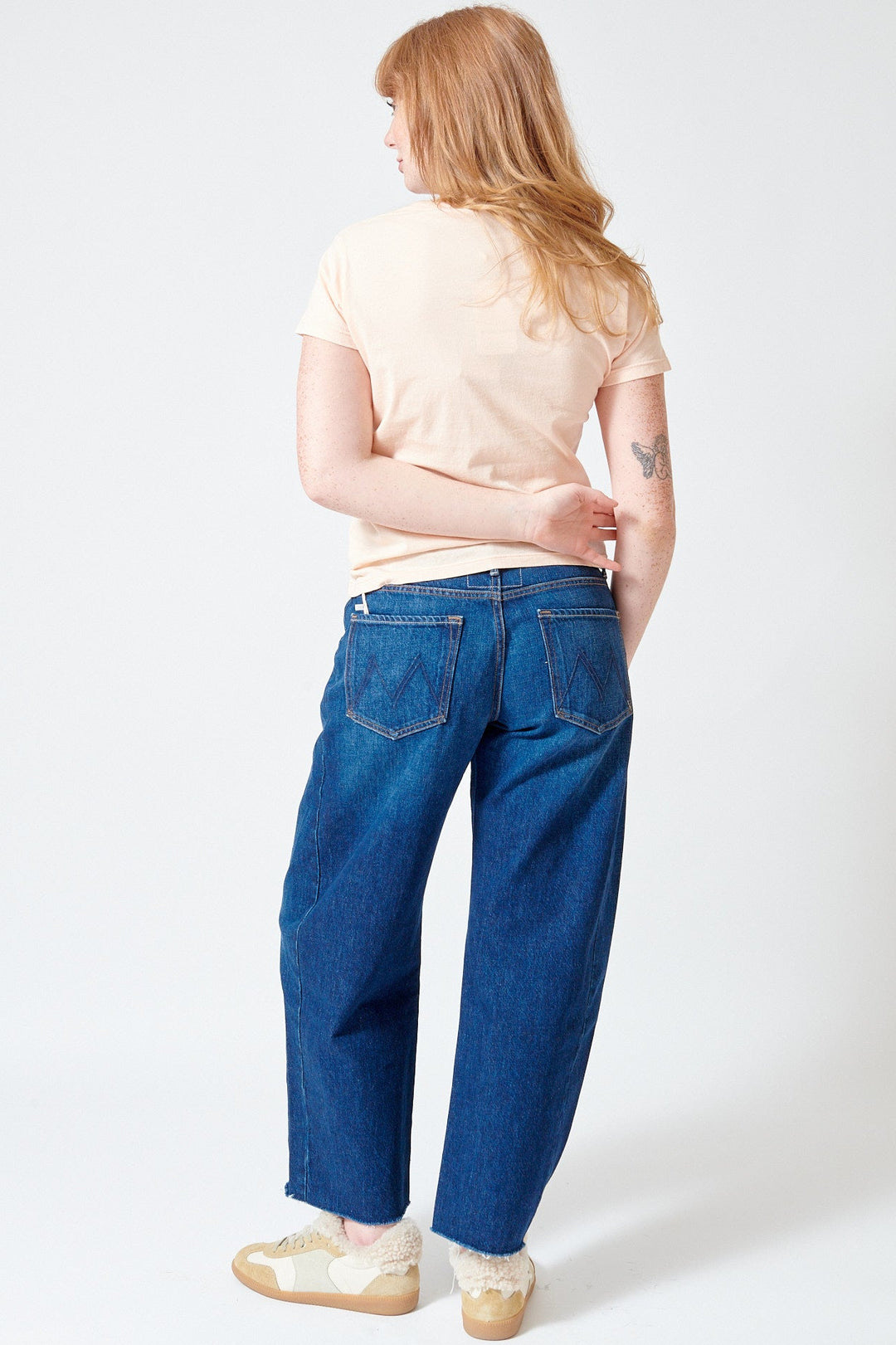 Waverly wearing Mother Denim Mid Rise Full Pipe Flood Fray rear view