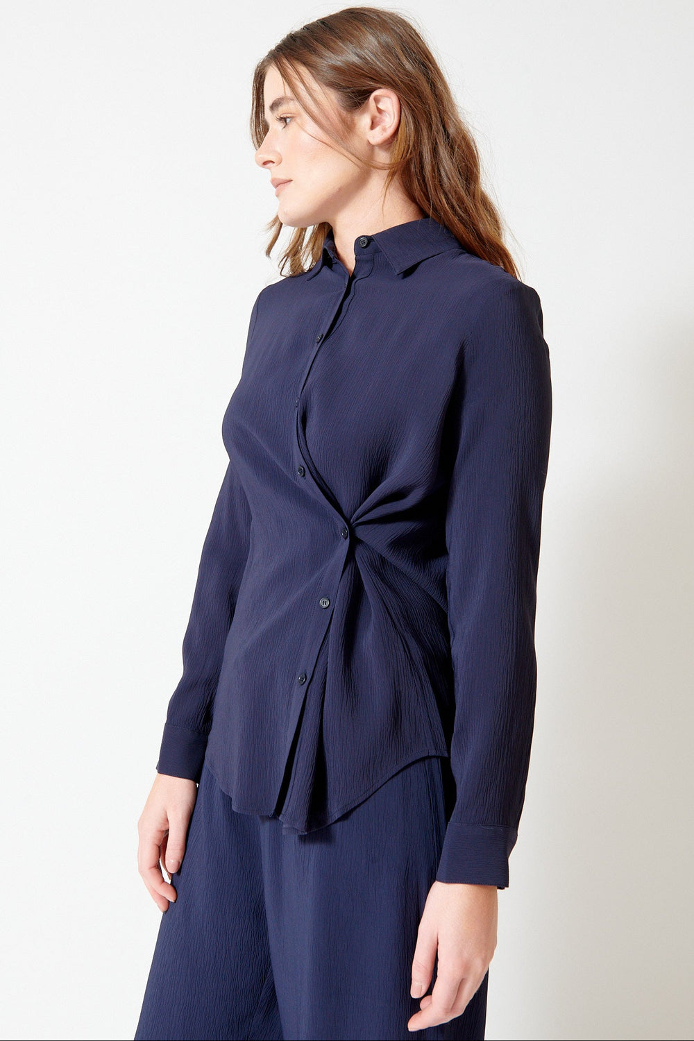 Julia wearing Apiece Apart Sodi Wrap Button Up front/side view
