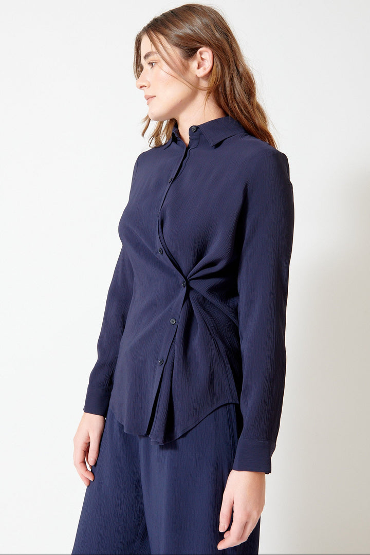 Julia wearing Apiece Apart Sodi Wrap Button Up front/side view