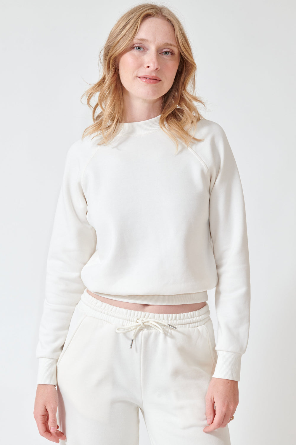 Madi wearing SPRWMN Shrunken Raglan Sweatshirt front view