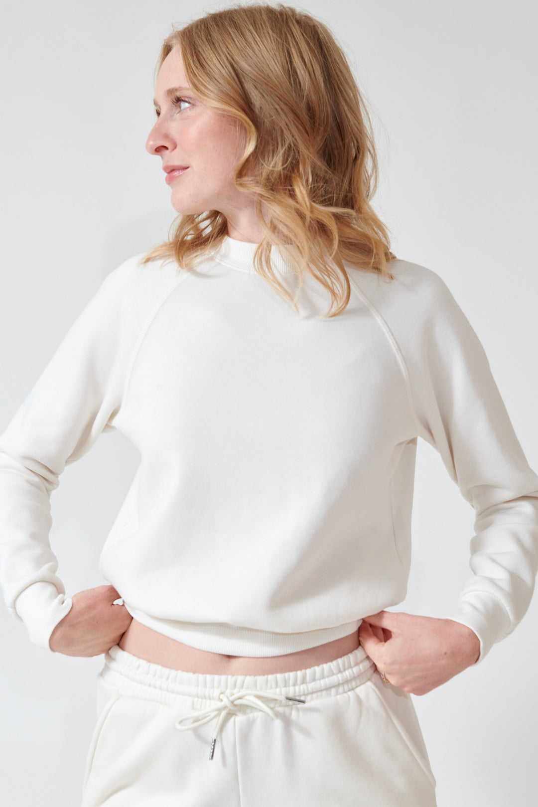 Madi wearing SPRWMN Shrunken Raglan Sweatshirt front view