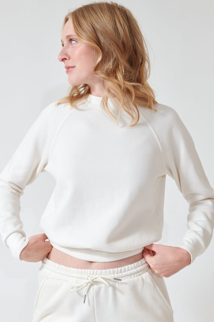 Madi wearing SPRWMN Shrunken Raglan Sweatshirt front view