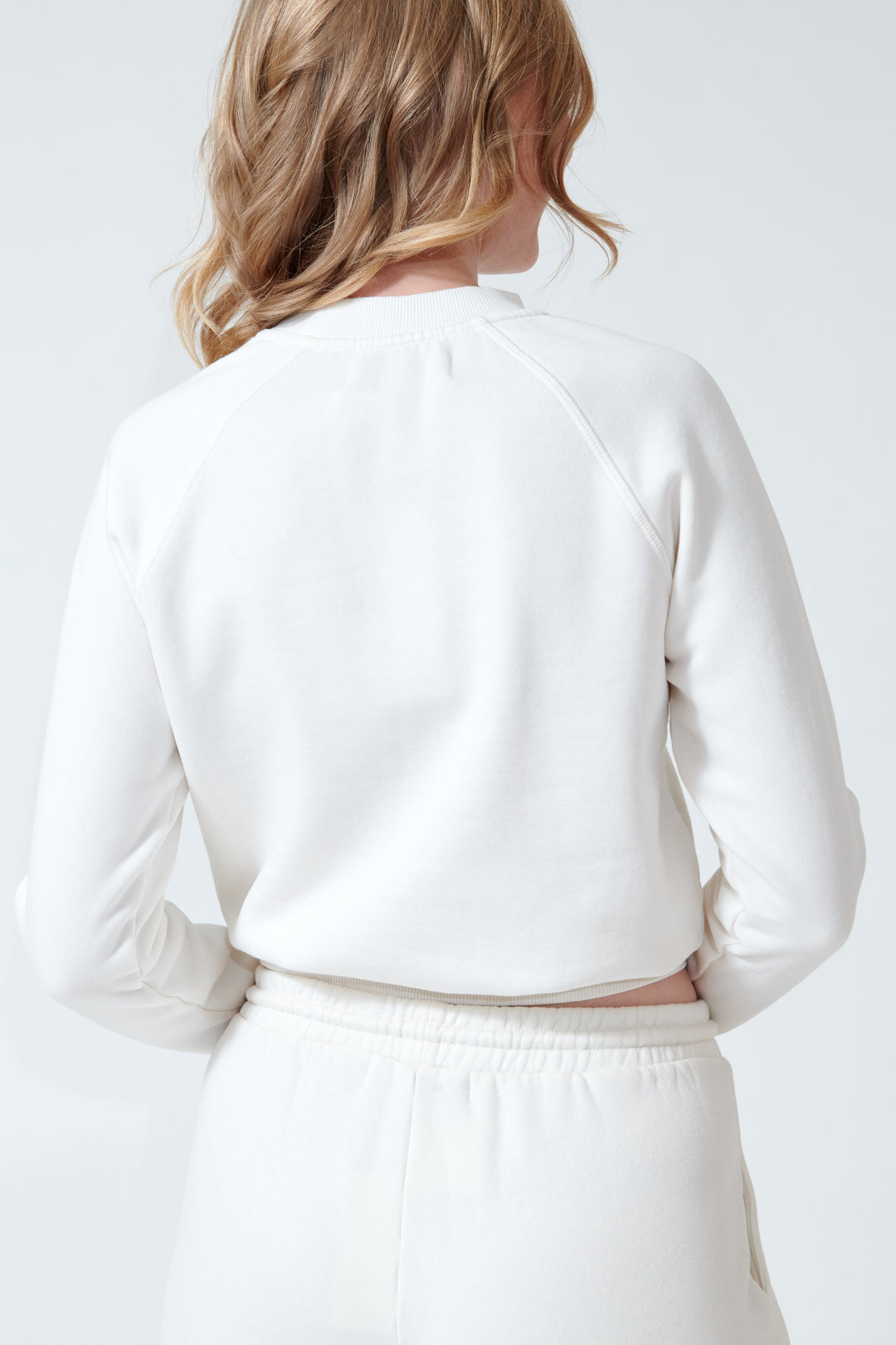 Madi wearing SPRWMN Shrunken Raglan Sweatshirt rear view