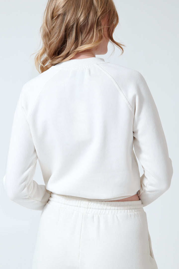 Madi wearing SPRWMN Shrunken Raglan Sweatshirt rear view