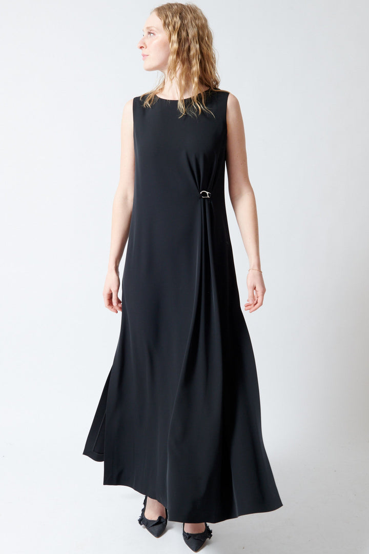 Madi wearing Herno Fluid Diagonal Sleeveless Bateau Neck Dress front view