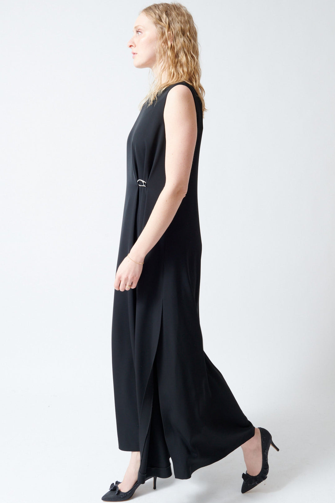 Madi wearing Herno Fluid Diagonal Sleeveless Bateau Neck Dress side view