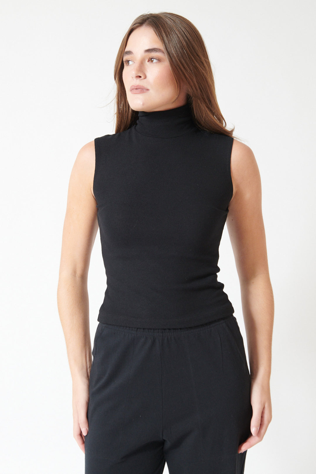 Laruen in LESET Lauren Sleeveless Turtleneck Top, black, front view.